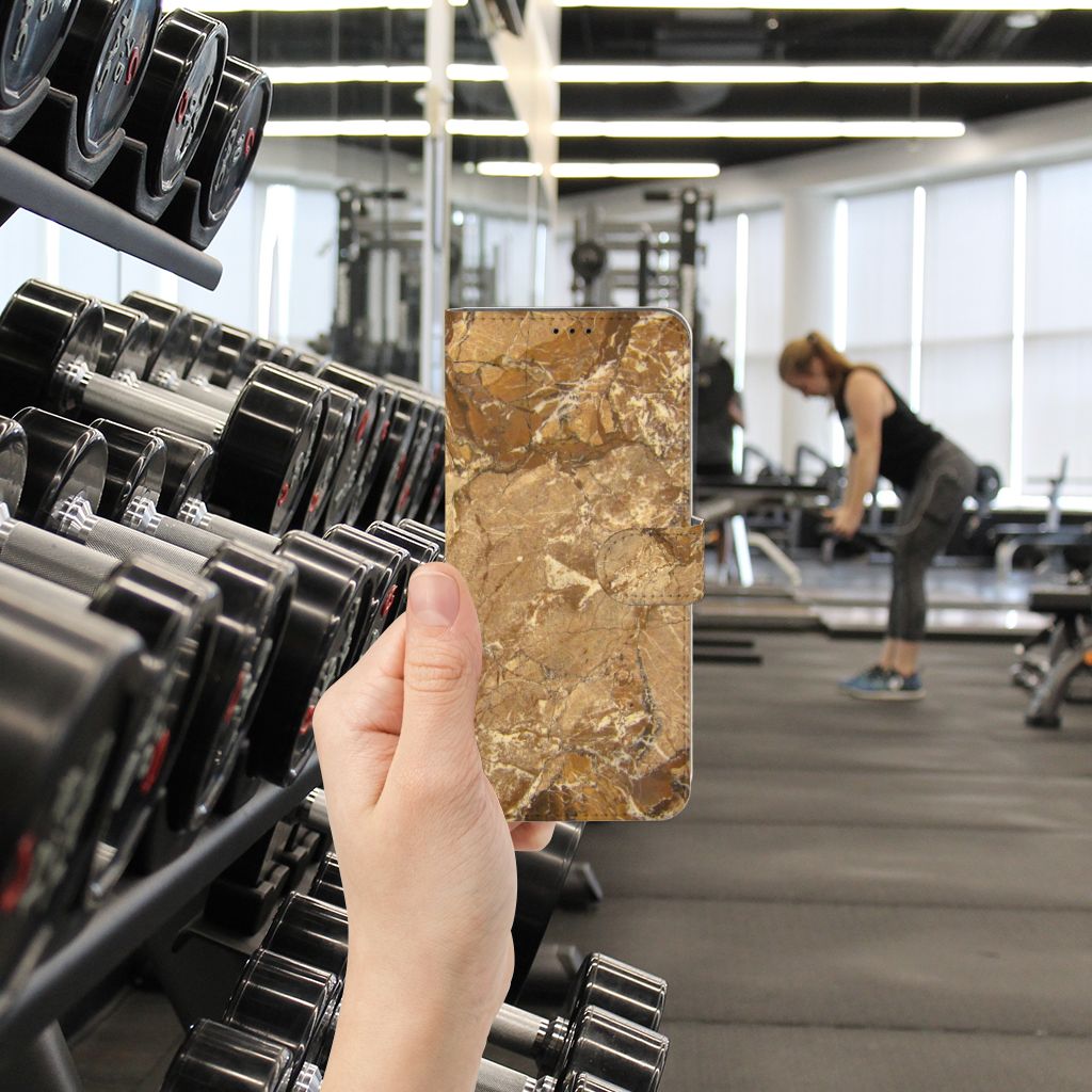 Motorola Edge 20 Pro Bookcase Marmer Creme in gym setting with weights in the background.