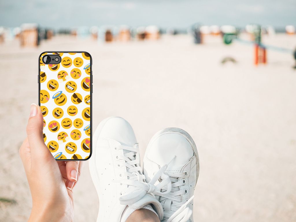 Hand holding iPhone SE 2022 | SE 2020 | 7/8 Back Case Emoji on a beach background with white sneakers.