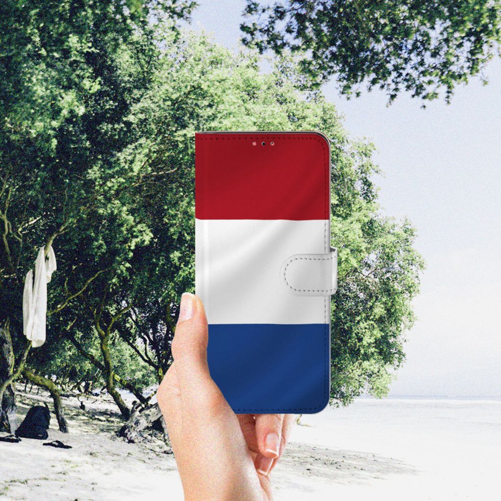 Samsung Galaxy A13 (4G) Bookstyle Case Nederlandse Vlag in een hand met natuurlijke achtergrond.