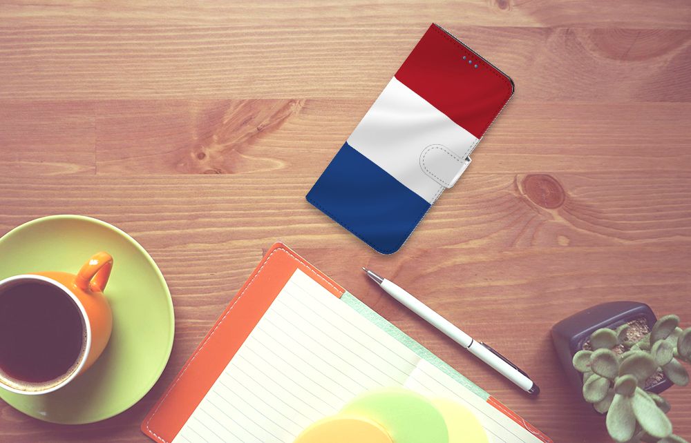 Motorola Moto E32 | Moto E32s Bookstyle Case Nederlandse Vlag op een houten tafel met een kopje koffie.