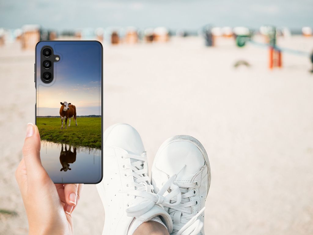 Samsung Galaxy A14 5G Dierenprint Telefoonhoesje Koe met koe op de achtergrond, ontspannend op het strand.