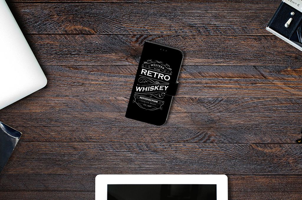 Apple iPhone 13 Book Cover Whiskey with retro whiskey design on a wooden desk 🥃.