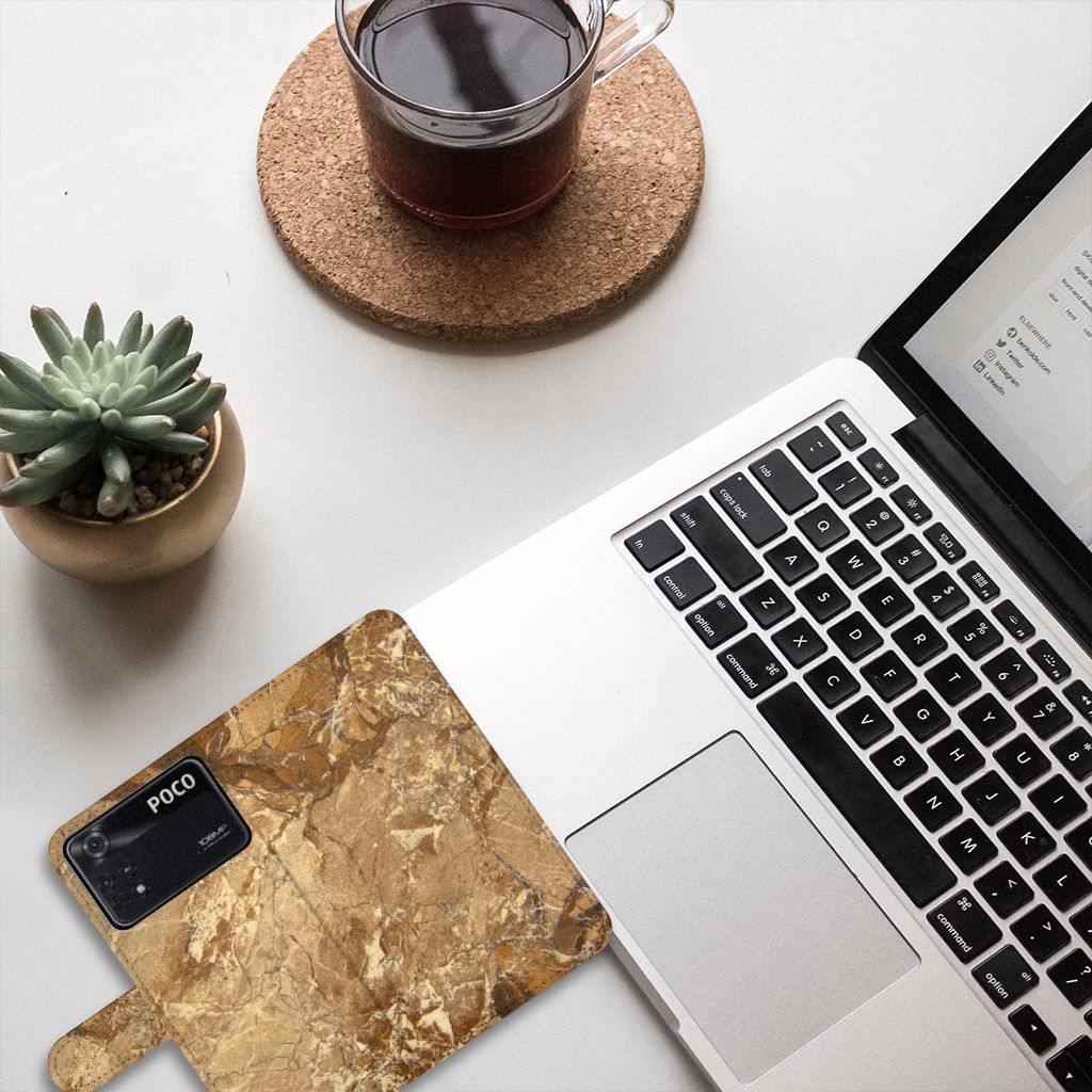 Xiaomi Poco X4 Pro 5G Bookcase Marmer Creme op een bureau met laptop en planten, luxe en functioneel.
