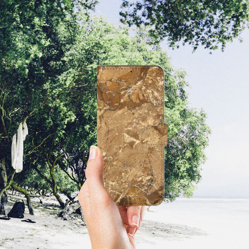 Samsung Galaxy A13 (4G) Bookcase Marmer Creme in hand with nature background, showcasing luxury design.