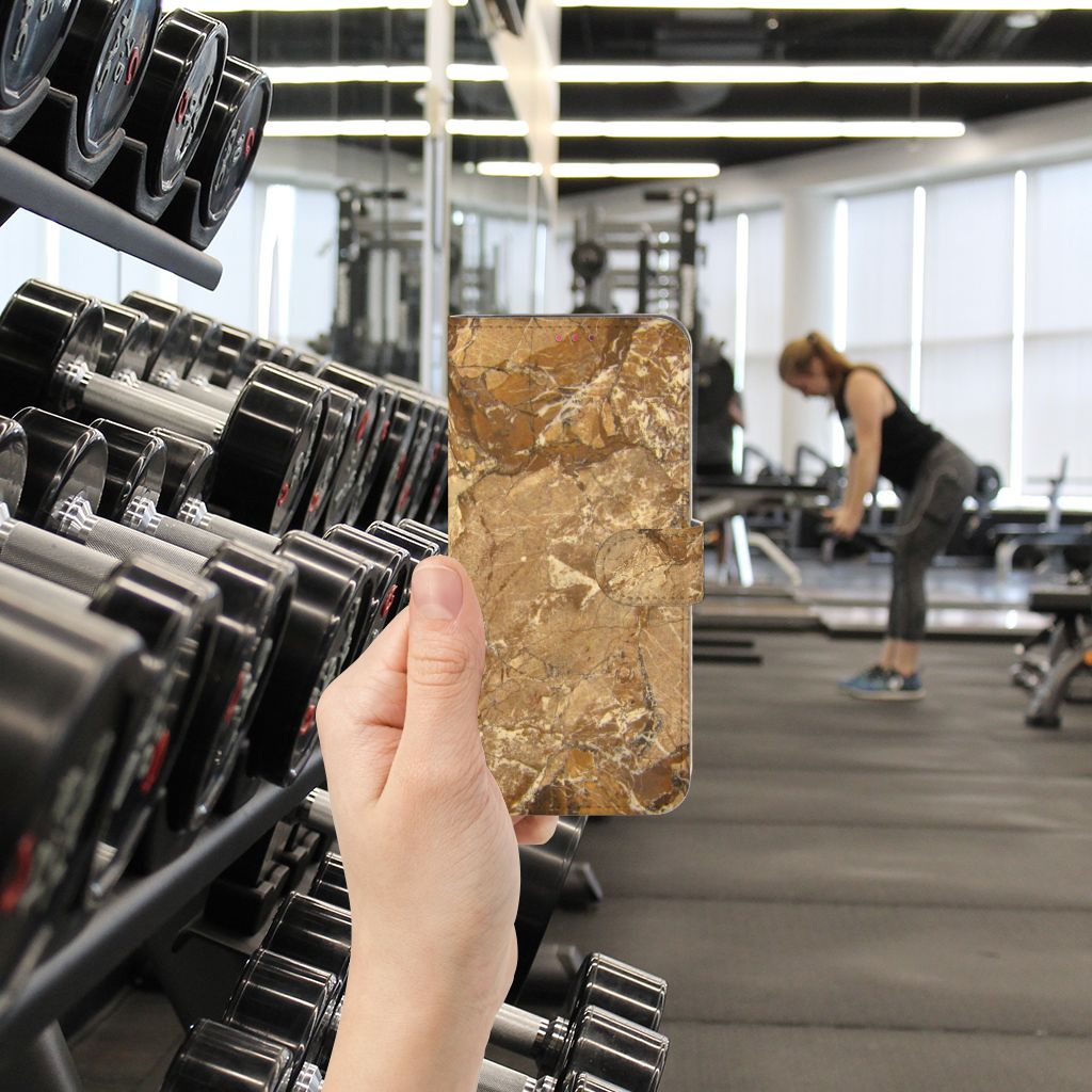 OPPO A54 5G | A74 5G | A93 5G Bookcase Marmer Creme in hand at gym with weights in background.