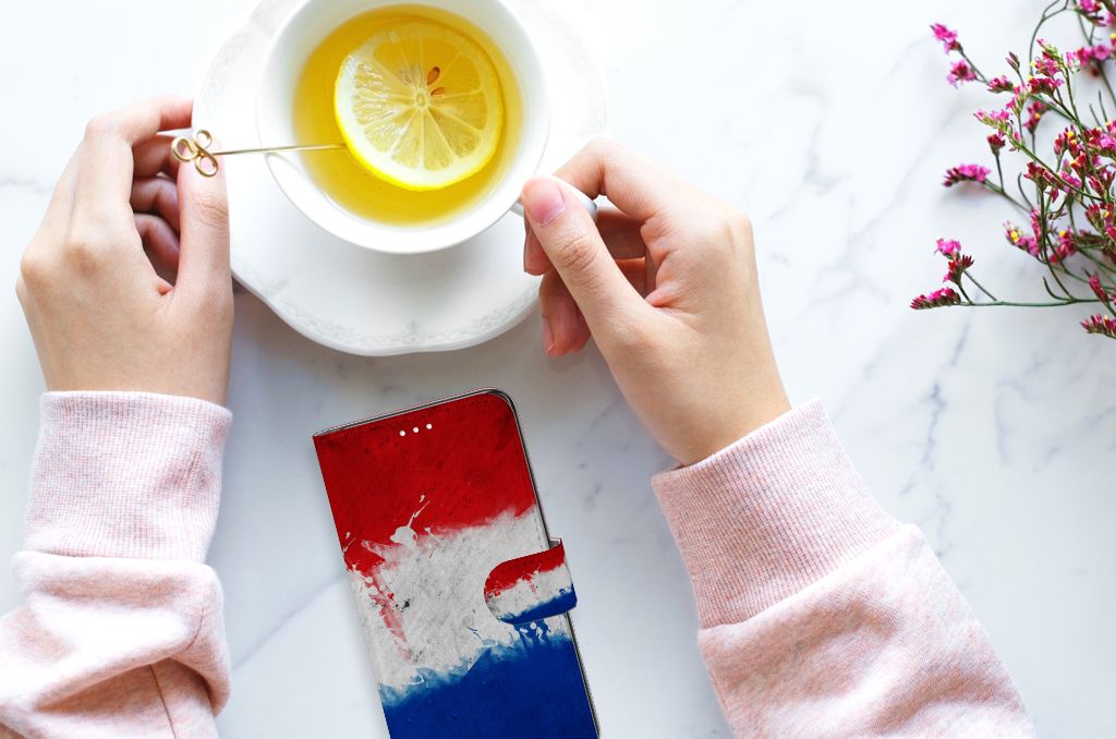 Samsung Galaxy S21 FE Bookstyle Case Nederland met een artistiek ontwerp van de Nederlandse vlag en een kopje thee.