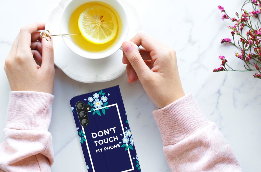 Samsung Galaxy A14 5G Design Case Flowers Blue DTMP next to tea with lemon on a marble table.