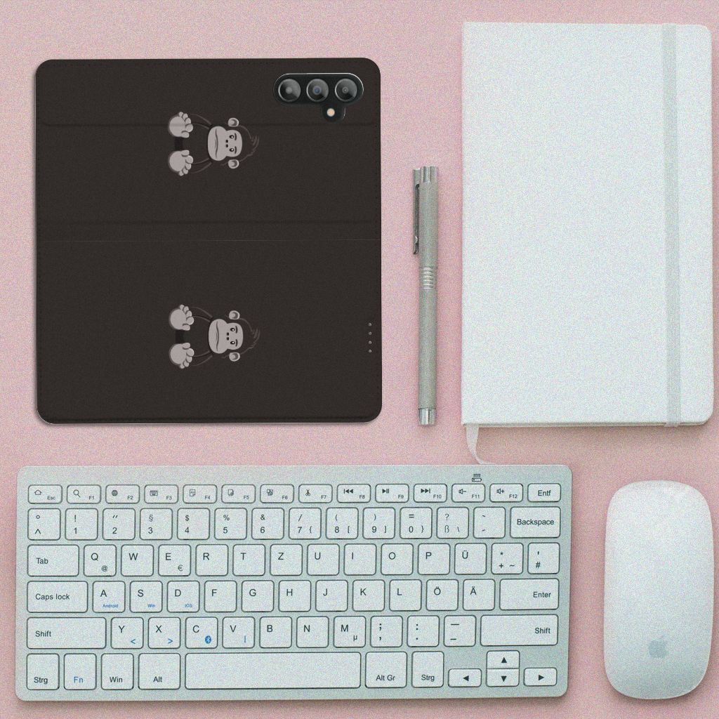 Samsung Galaxy A14 4G Magnet Case Gorilla design displayed on desk with keyboard and notebook.