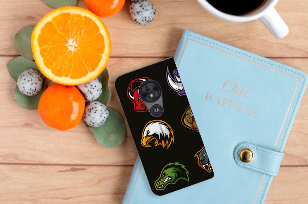 Motorola Moto G7 Play Magnet Case Cartoon with colorful designs on a wooden table with fruit and a notebook.
