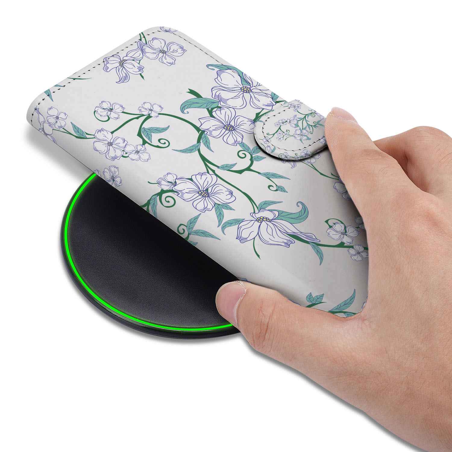 iPhone 16e Uniek Hoesje Blossom White being placed on a wireless charger with floral design.