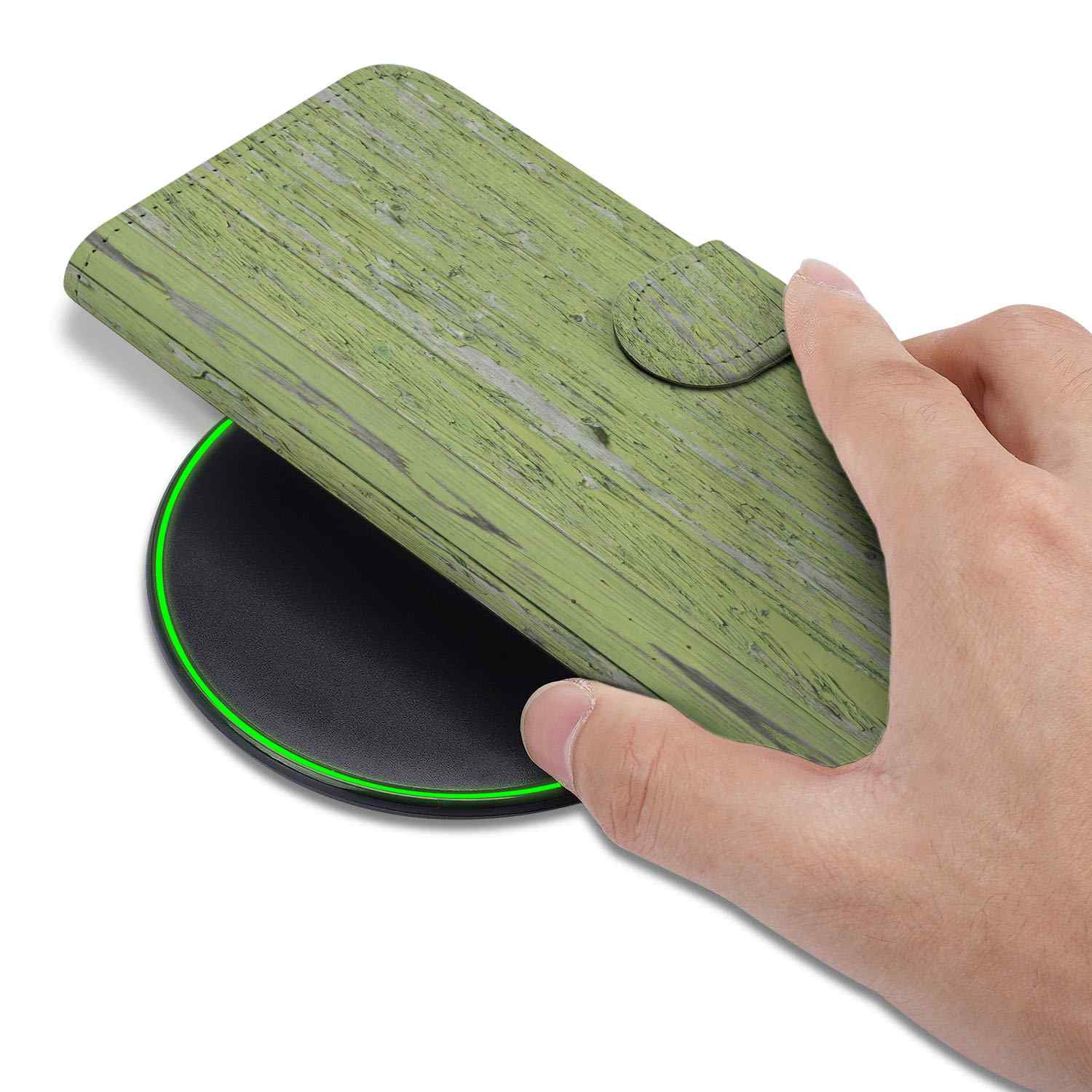 iPhone 16e Book Style Case Green Wood being placed on a wireless charger with a hand holding it.