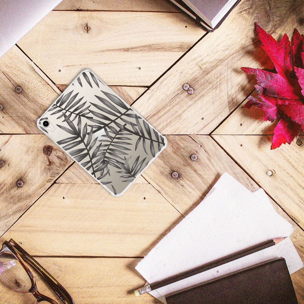 Apple iPad mini 6 (2021) Siliconen Hoesje Leaves Grey op een houten tafel met papieren en brillen.