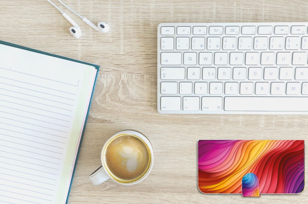 Book Case voor Apple iPhone 11 Pro Max Regenboog met kleurrijk ontwerp op een bureau naast een kop koffie.