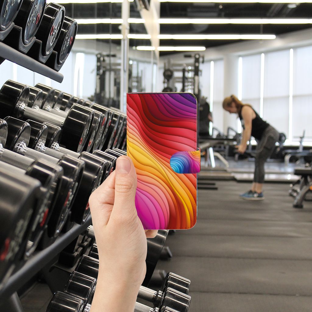 Book Case voor Google Pixel 7A Regenboog in gebruik tijdens een sportieve workout, met kleurrijk design 🌈.