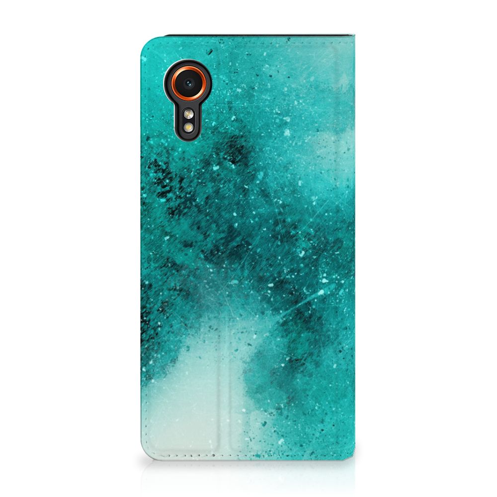 Bookcase Samsung Galaxy Xcover 7 Painting Blue met een turquoise design, biedt gebruiksgemak en stijlvolle bescherming 🎨.