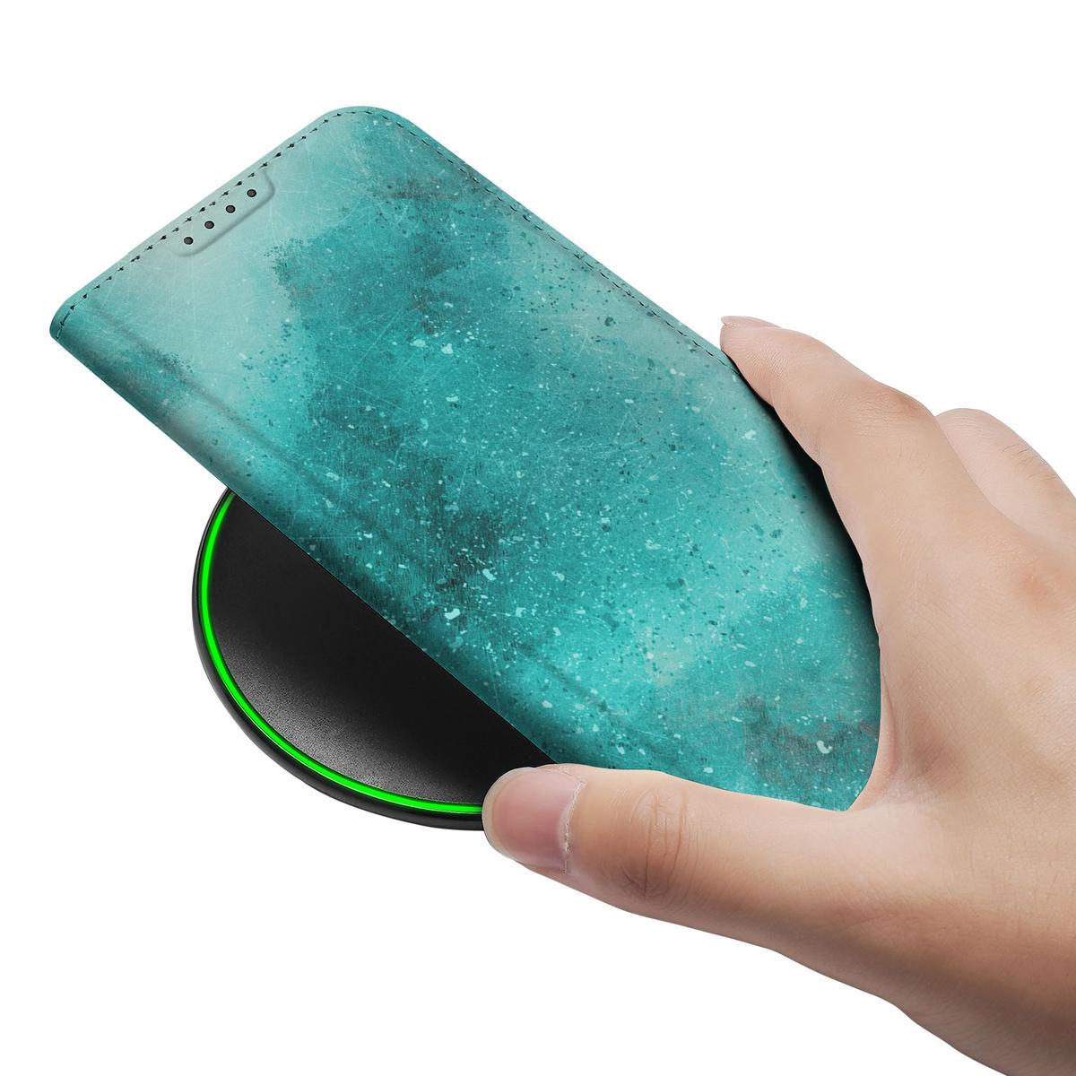 Apple iPhone 16e Bookcase voor Apple iPhone 16e Painting Blue hand aan draadloze oplader