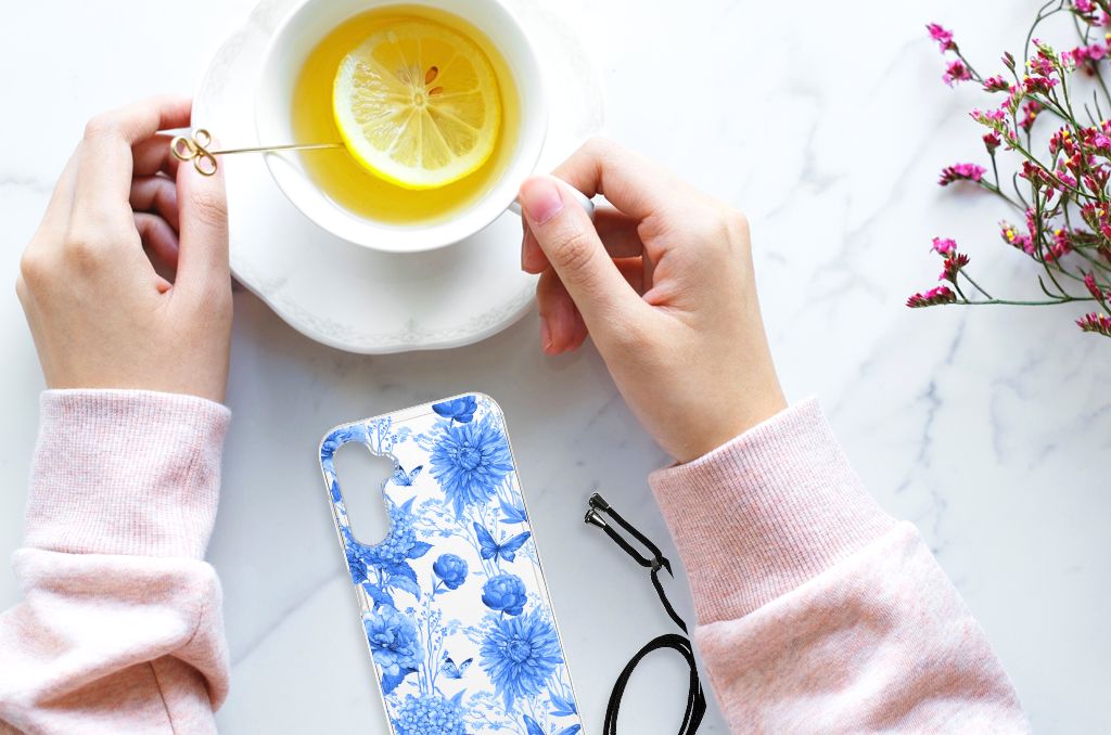 Case voor Samsung Galaxy A14 5G Flowers Blue gedecoreerd met blauwe bloemen, naast een kopje kruidenthee.