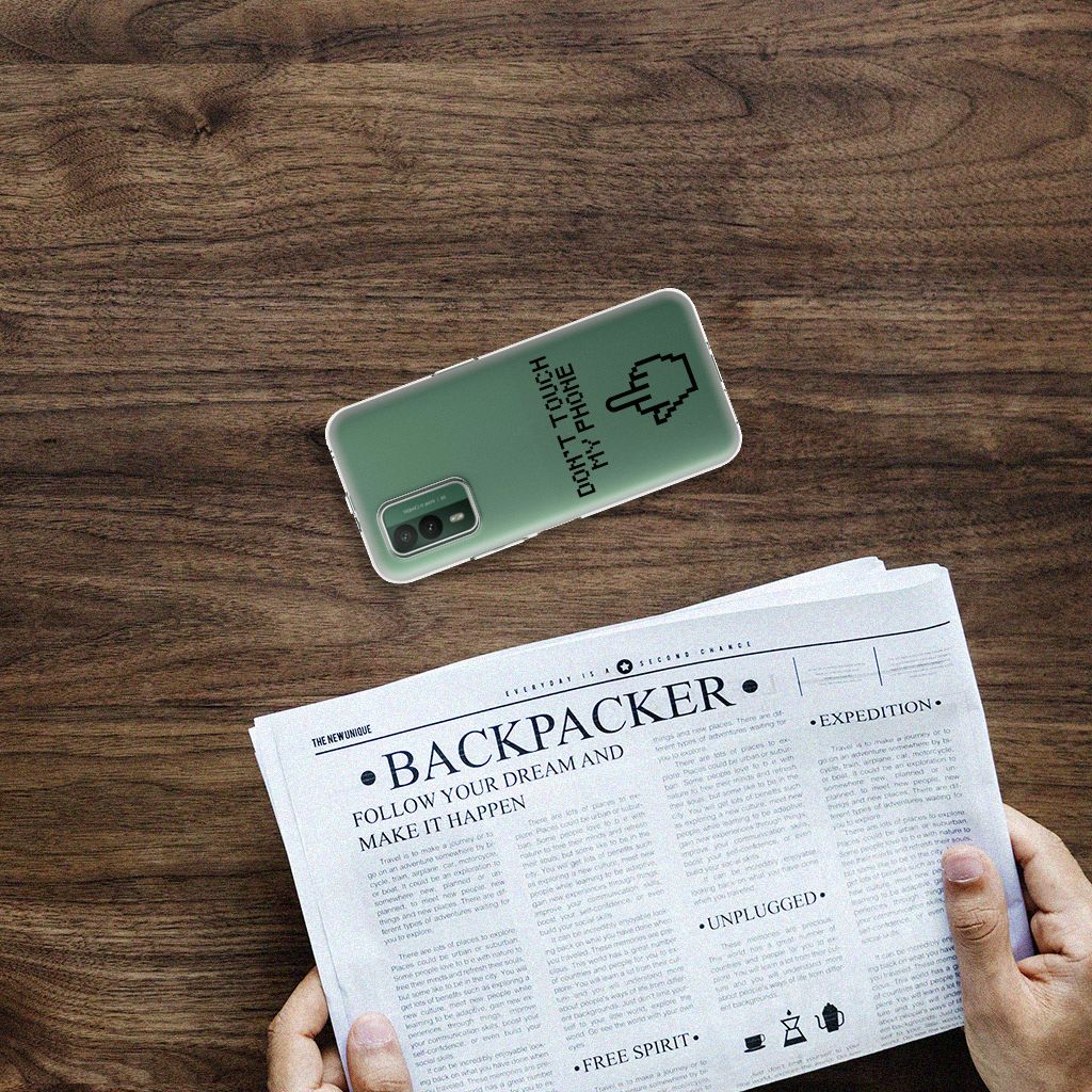 Nokia XR21 Silicone-hoesje Finger Don't Touch My Phone op een tafel met krant, uniek ontwerp voor bescherming en uitstraling.