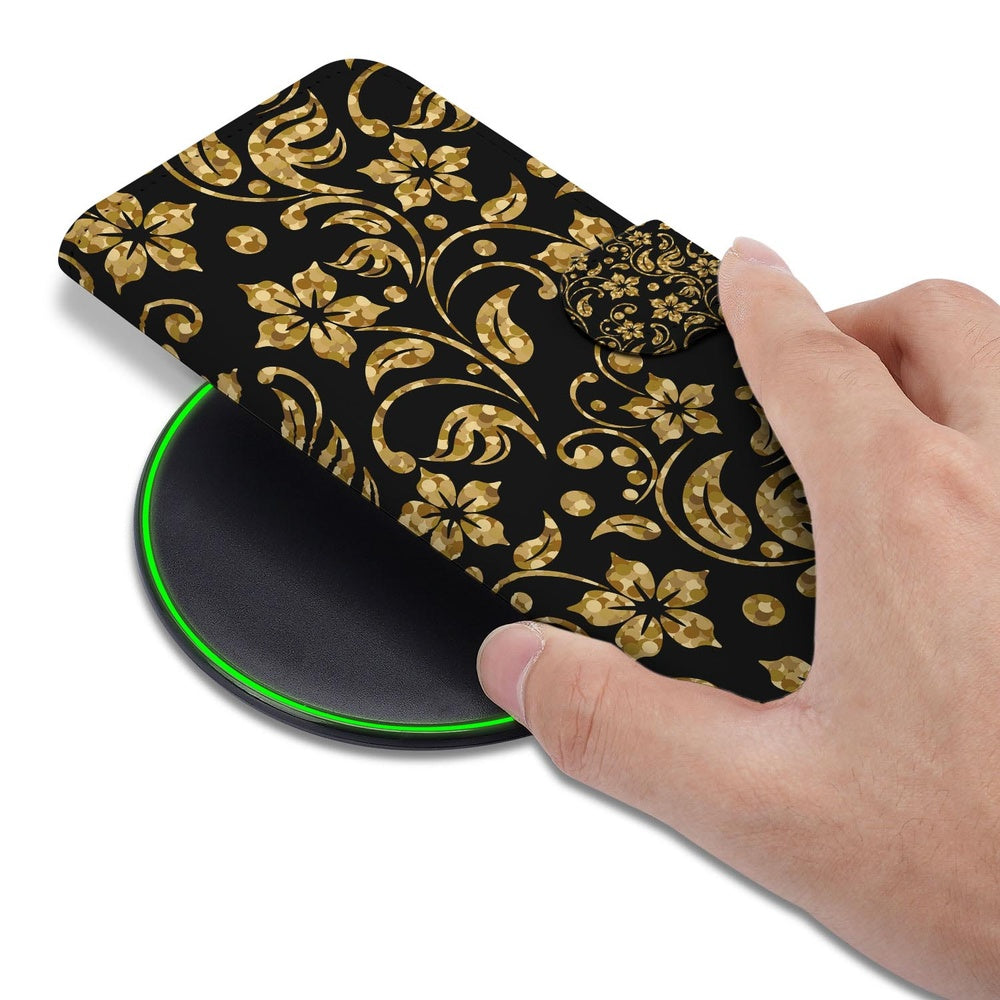 Samsung Galaxy S26 Ultra Boekhoes Gouden Bloemen met Pasjeshouder op een draadloze oplader met hand erop