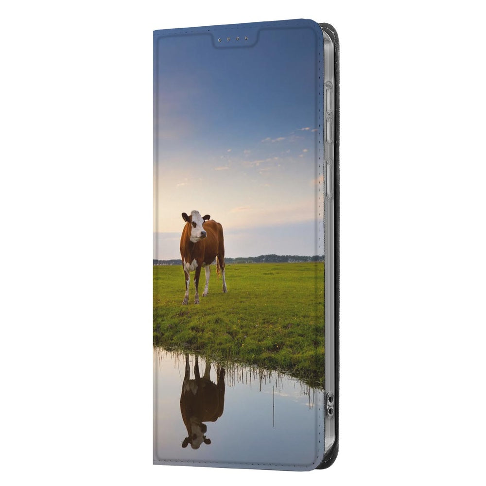 Samsung Galaxy S26 Ultra Book Cover Koe voorkant met koe bij zonsondergang en spiegeling in het water.