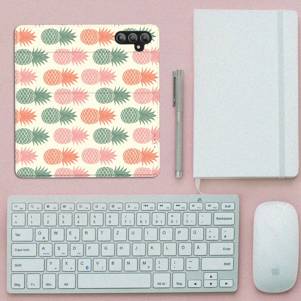 Samsung Galaxy A14 4G Flip Style Cover Ananas on a desk with keyboard and notebook