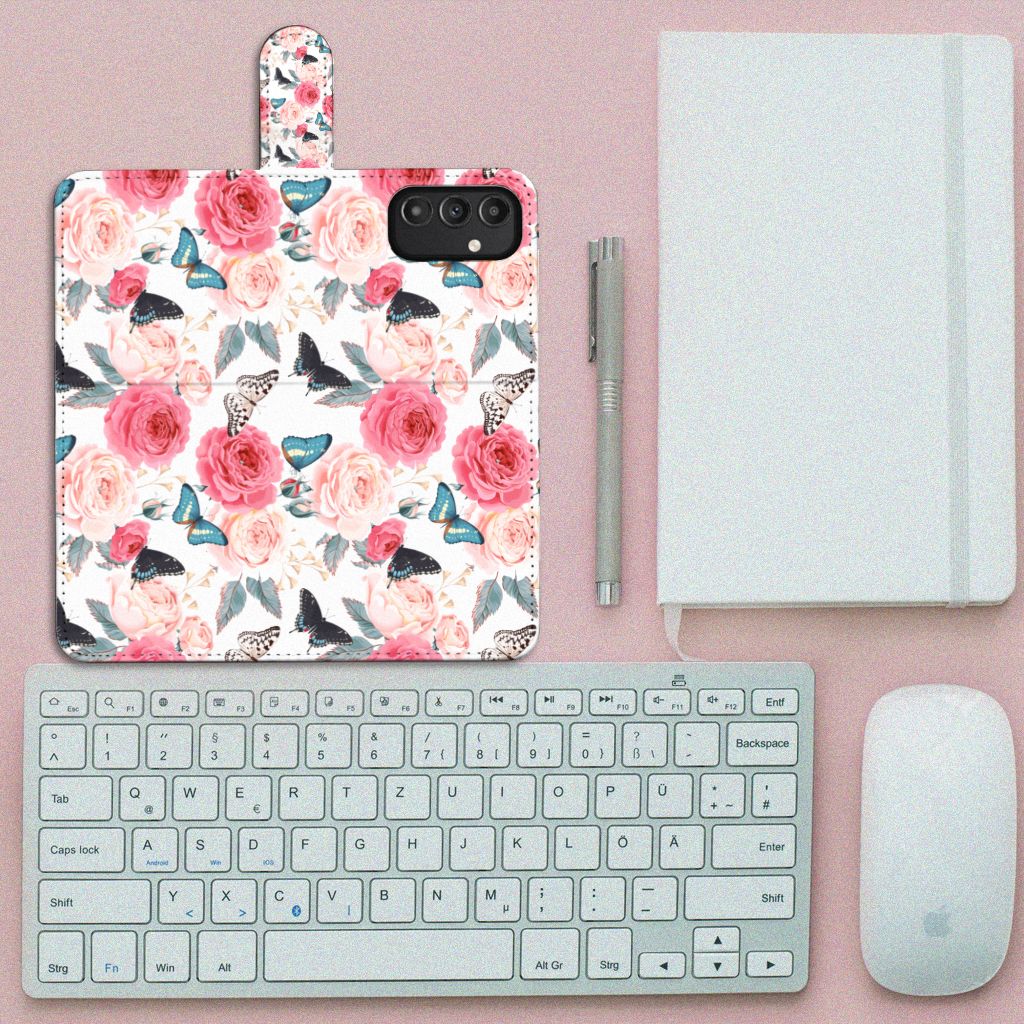 Samsung Galaxy A14 4G Hoesje Butterfly Roses met bloemen en vlinders naast een toetsenbord en notitieboek.