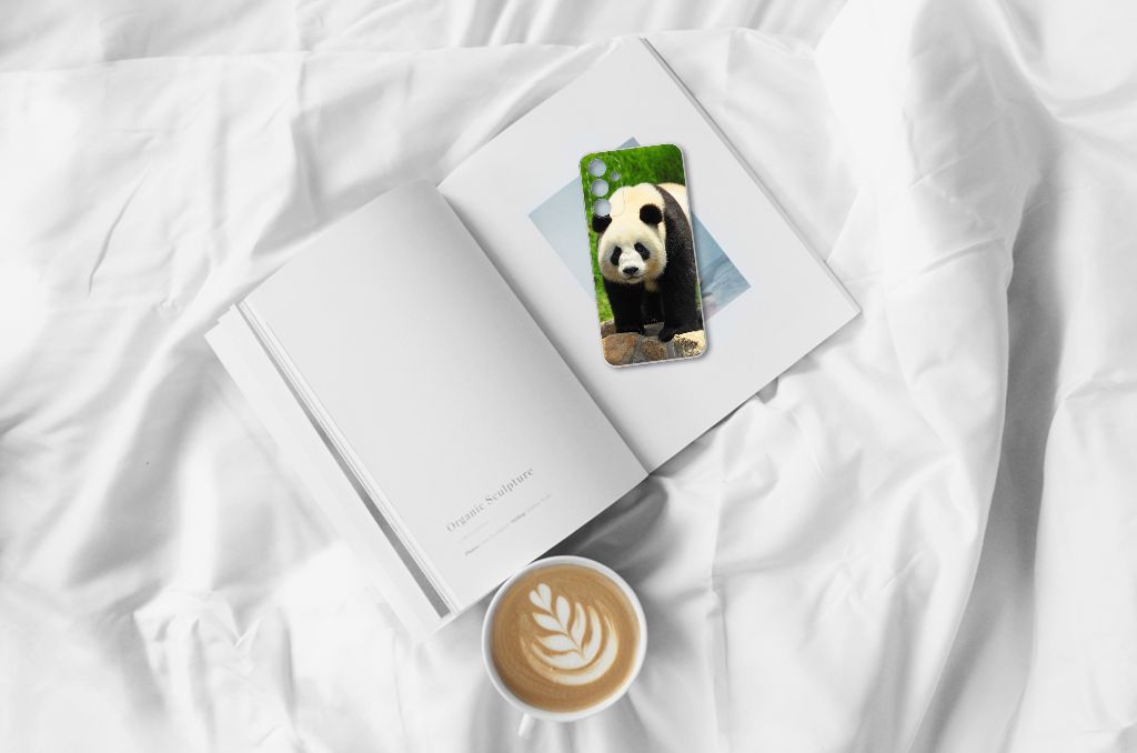Afbeelding van een Samsung Galaxy A15 TPU Hoesje Panda op een boek met een kopje koffie ☕. Perfect cadeau voor gebruiksgemak en bescherming.