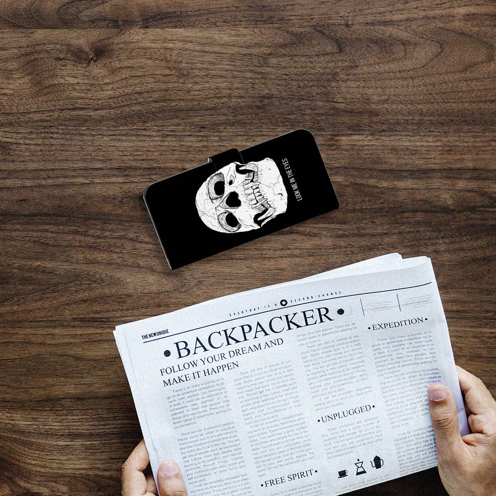 Telefoonhoesje met Naam Motorola Moto G24 | G04 | G24 Power Skull Eyes op een houten tafel naast een krant.