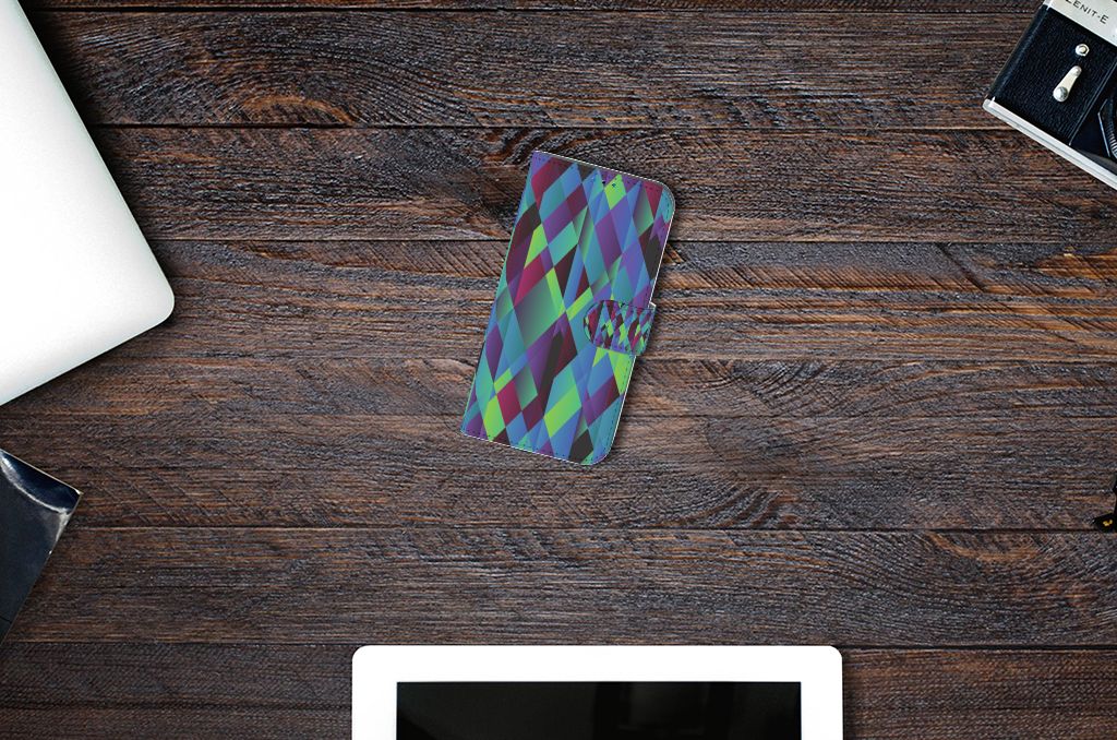 iPhone 14 Pro Book Case Abstract Green Blue met kleurrijk kunstzinnig ontwerp op houten tafel