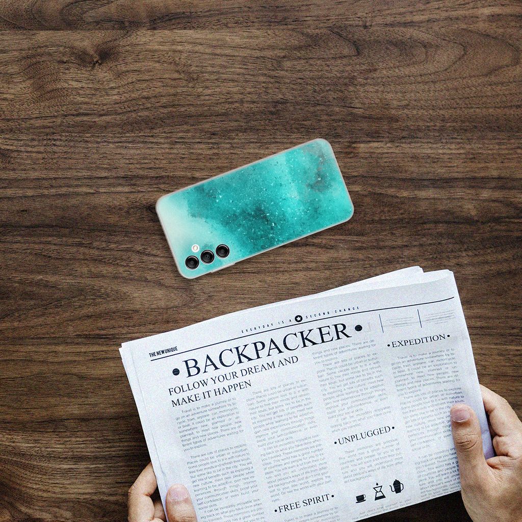 Hoesje maken Samsung Galaxy A14 5G Painting Blue op een tafel met een krant ernaast.