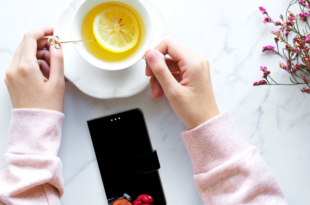 Samsung Galaxy S21 FE Wallet Case met Pasjes Sports naast een kopje thee met citroen.