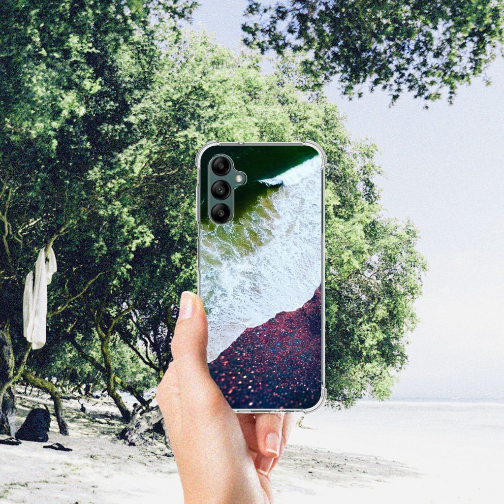 Samsung Galaxy A14 5G/4G Shockproof Case Sea in Space displayed on a beach with trees in the background.