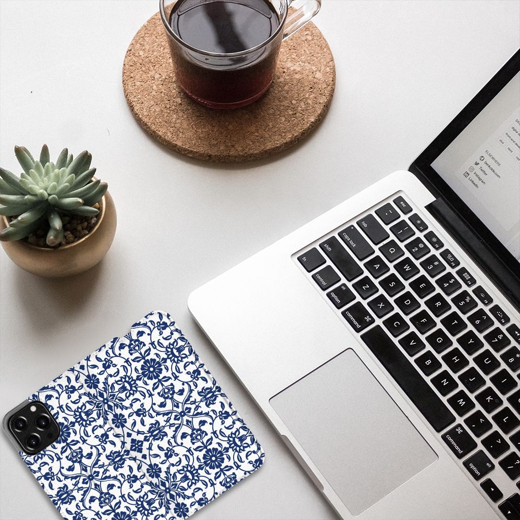 iPhone 13 Pro Max Smart Cover Flower Blue on desk with laptop and plant, showcasing its beautiful floral design.