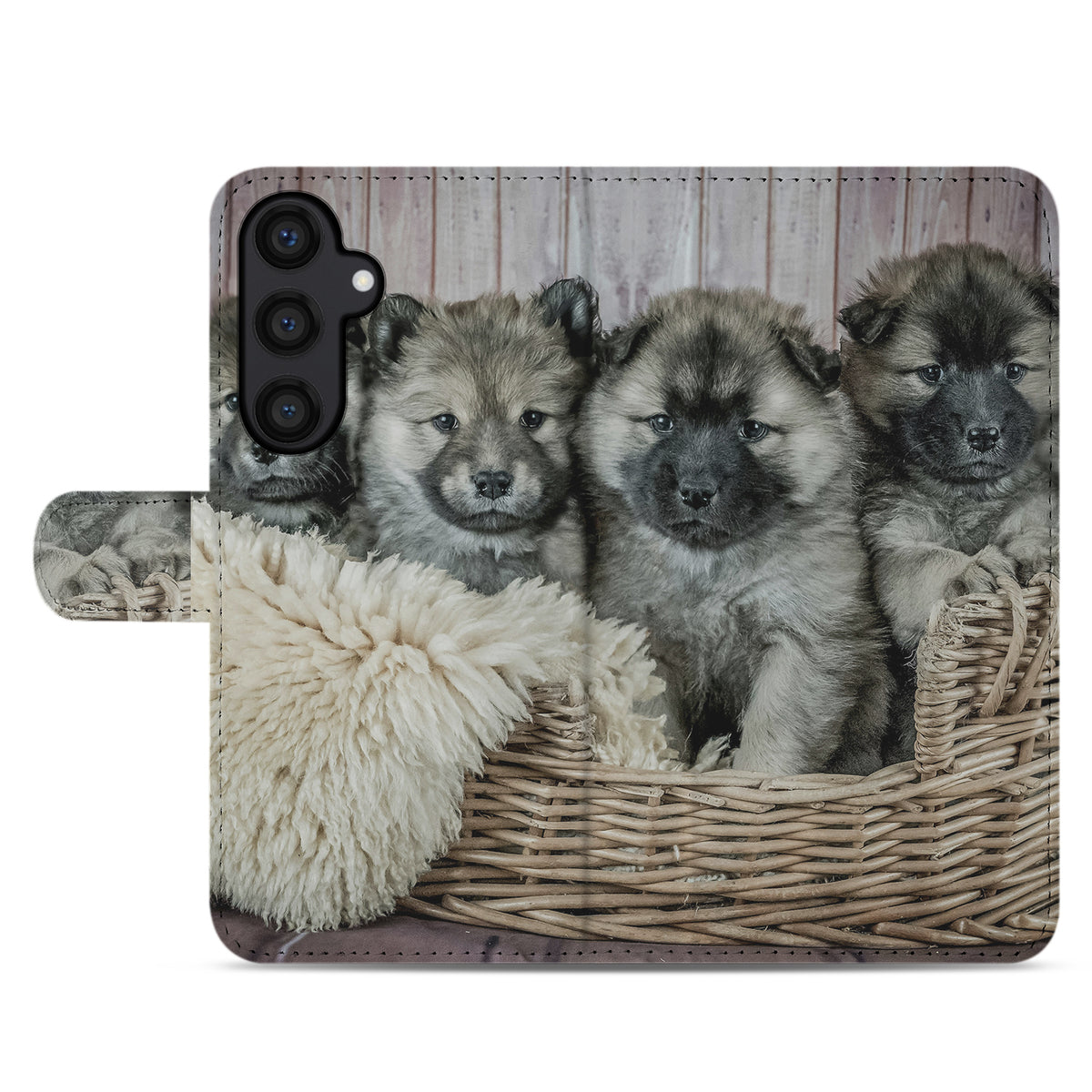 Plat aanzicht van de A15 bookcase-achterkant: drie pups in een rieten mand op een witte vacht
