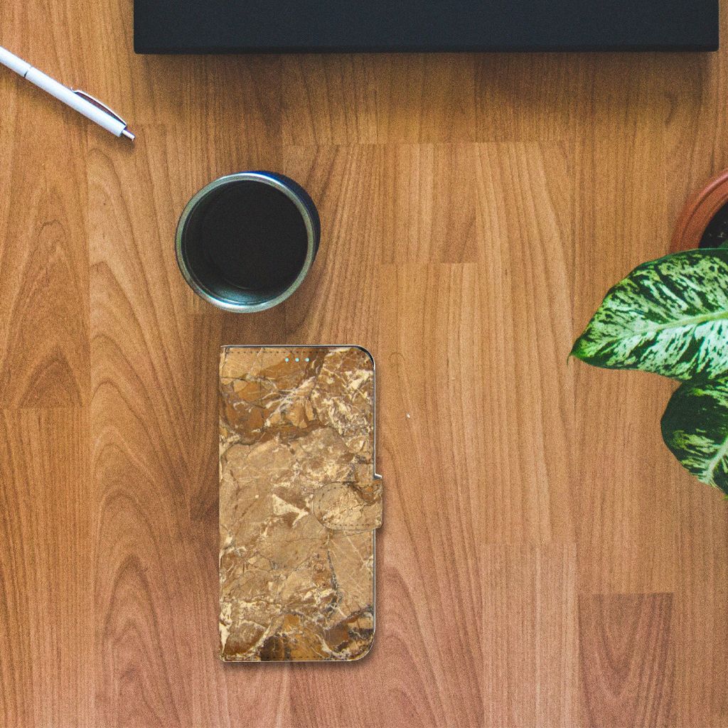 OPPO A76 | A96 Bookcase Marmer Creme on a wooden table with a cup of coffee and a green plant.