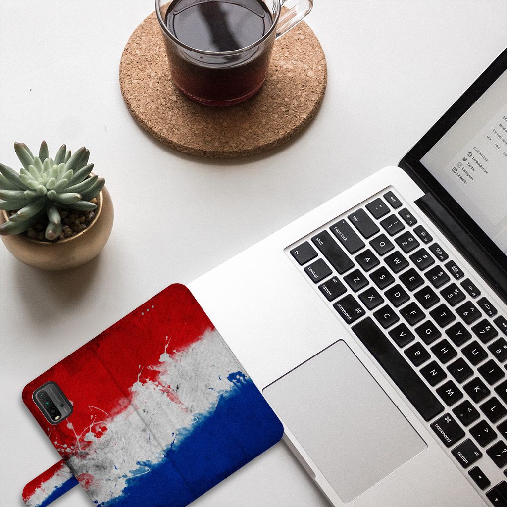 Xiaomi Redmi 9T | Poco M3 Bookstyle Case Nederland met Nederlandse vlag design op een bureau met laptop en koffie.