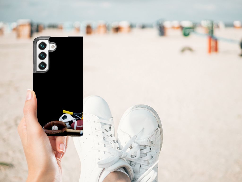 Samsung Galaxy S22 Hippe Standcase Sports design shown on a beach with sports images and white sneakers.