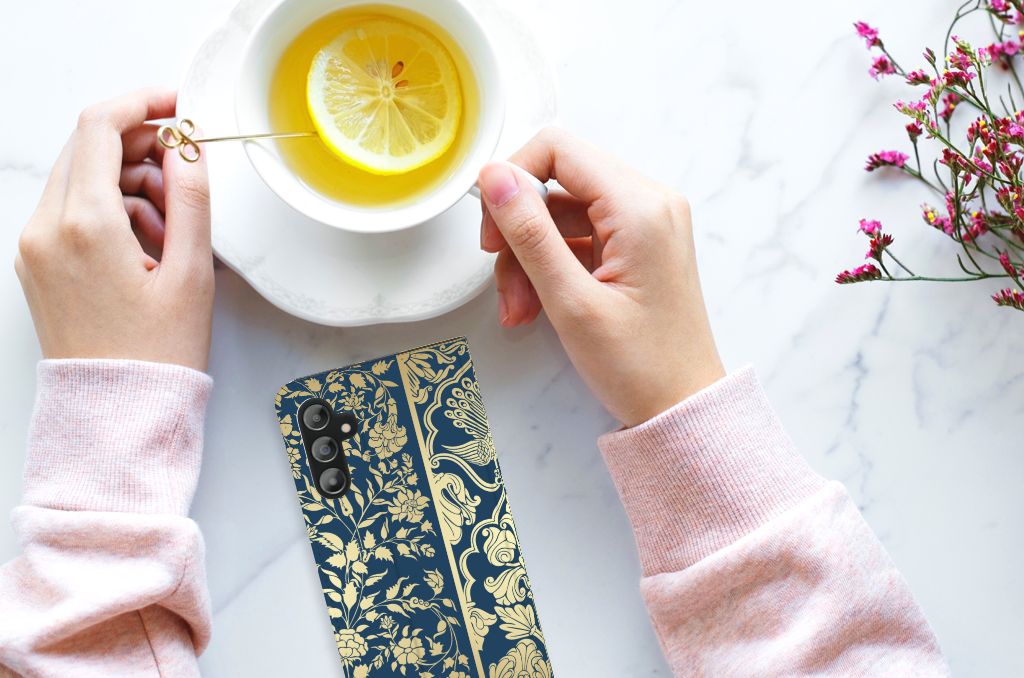 Samsung Galaxy A14 5G Smart Cover Beige Flowers next to a cup of tea and flowers on a marble table.