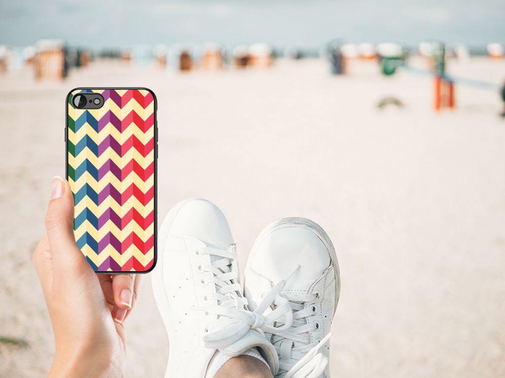 iPhone SE 2022 | SE 2020 | 7/8 Back Case Zigzag Multi Color held in a hand on the beach with white sneakers.