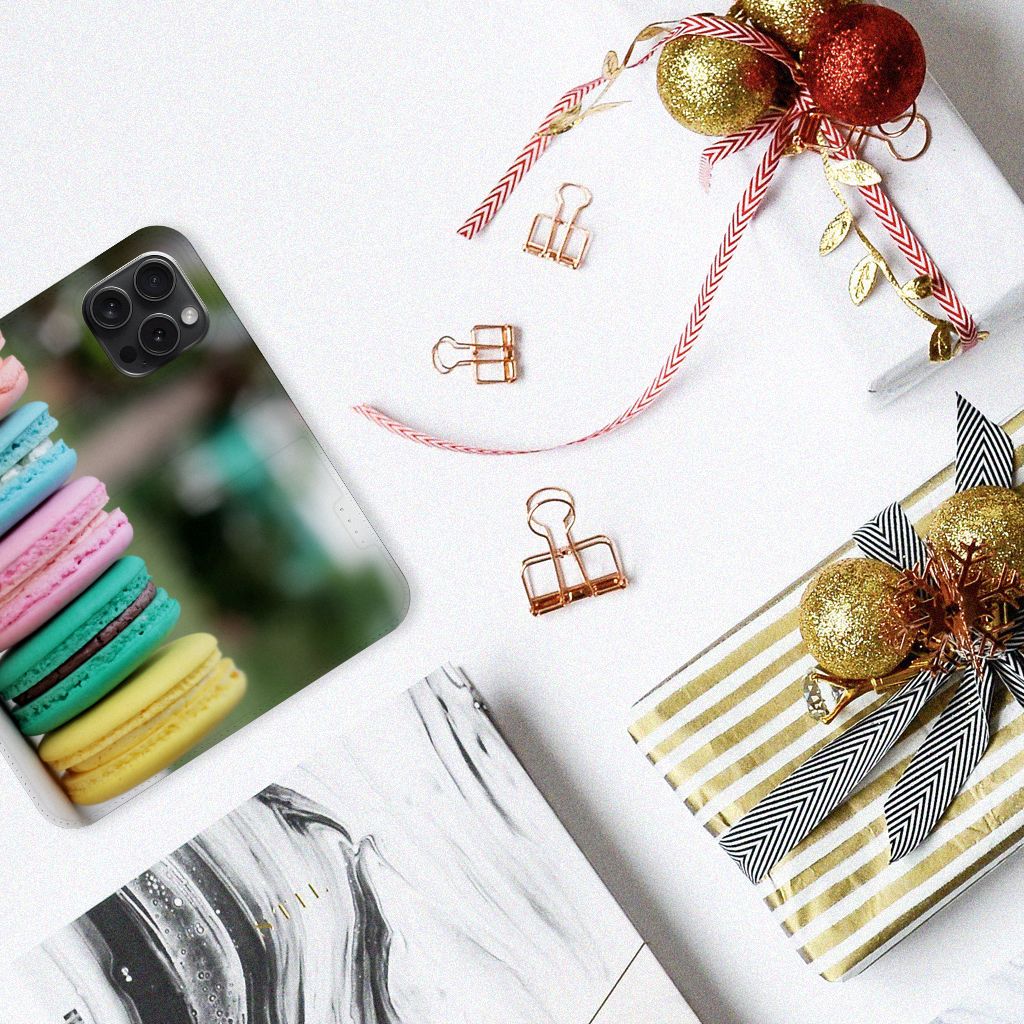 iPhone 15 Pro Flip Style Cover Macarons met kleurrijke macarons op een tafel met feestdecoraties.