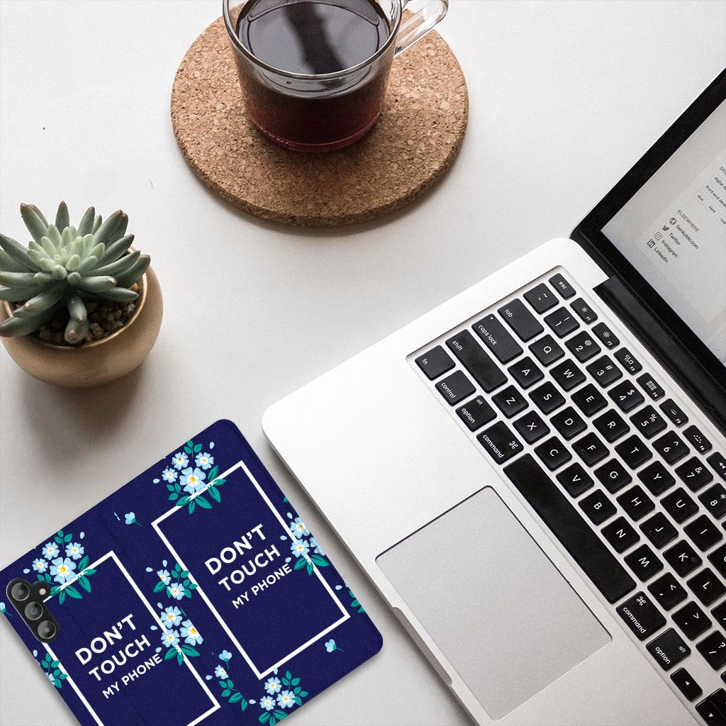 Samsung Galaxy A14 5G Design Case Flowers Blue DTMP on desk beside laptop and coffee.