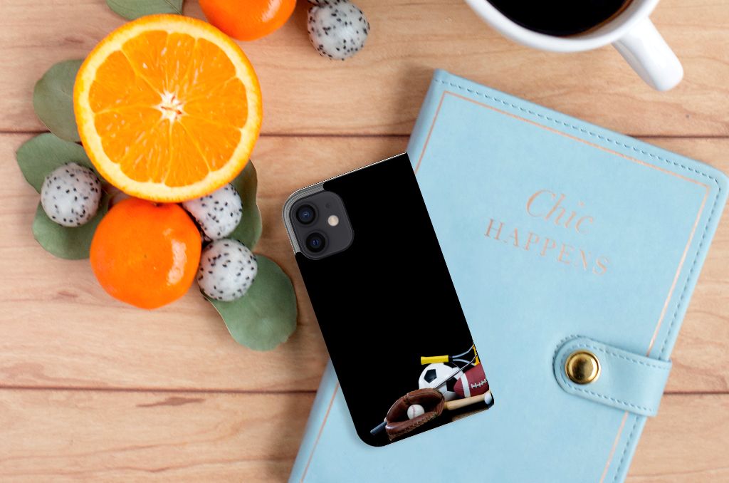 iPhone 12 Mini Hippe Standcase Sports design with sports icons on a wooden table with fruit and a notebook.