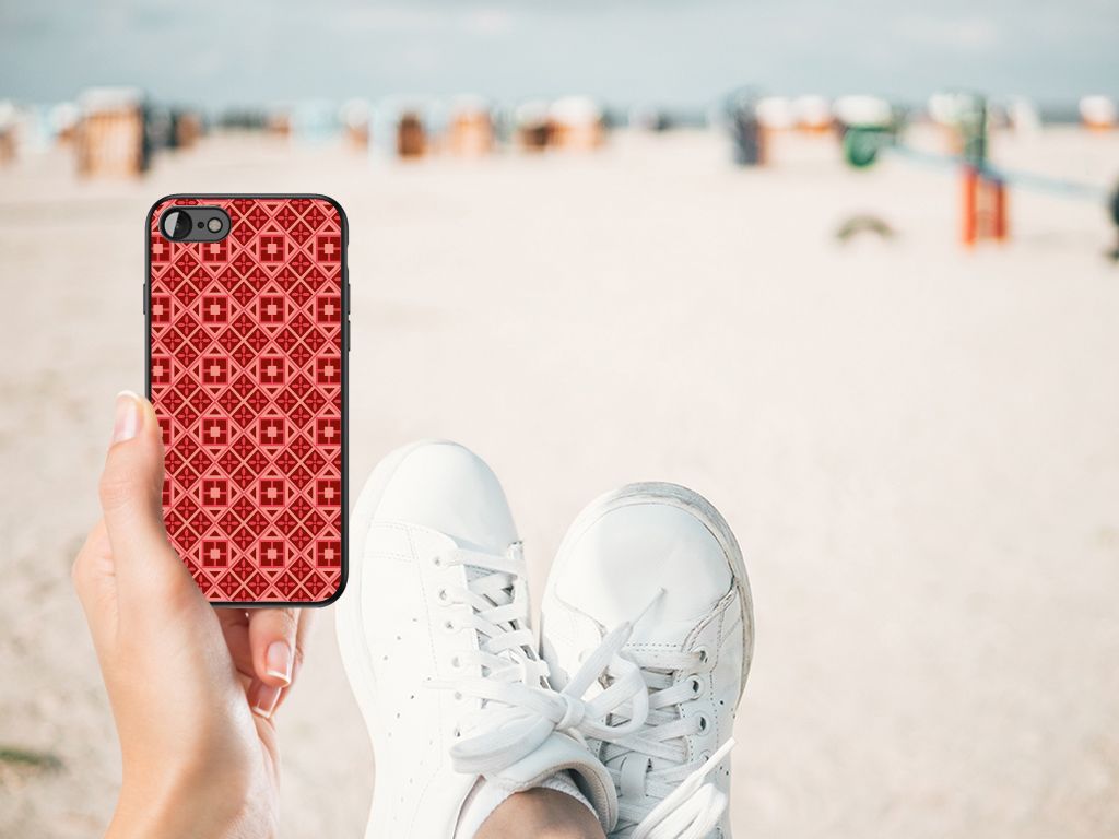 iPhone SE 2022 | SE 2020 | 7/8 Back Case Batik Rood in hand at the beach with white sneakers.