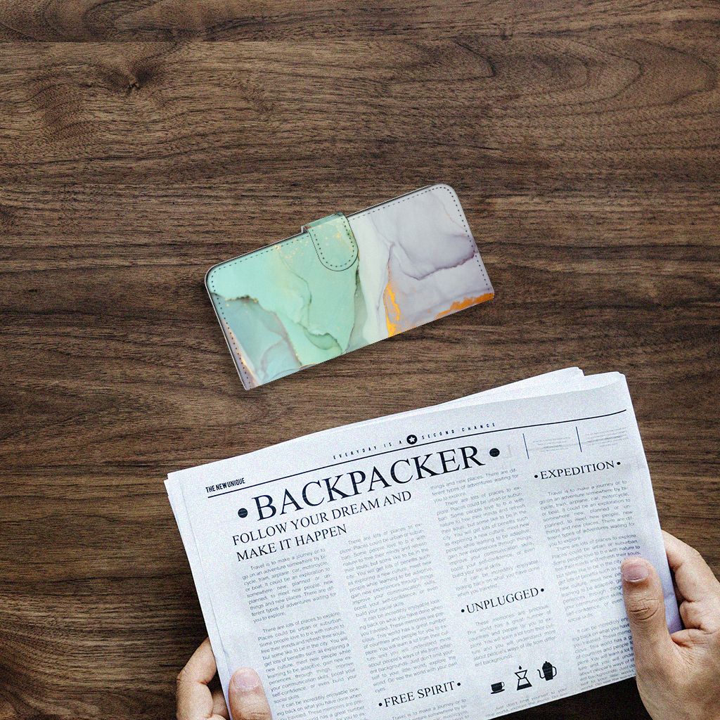 Hoesje voor Samsung Galaxy A14 4G Watercolor Mix op een tafel met een krant.