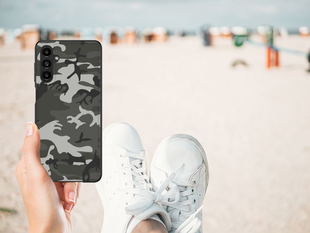 Samsung Galaxy A14 5G Back Case Army Light in camo design held above beach sand and white sneakers.