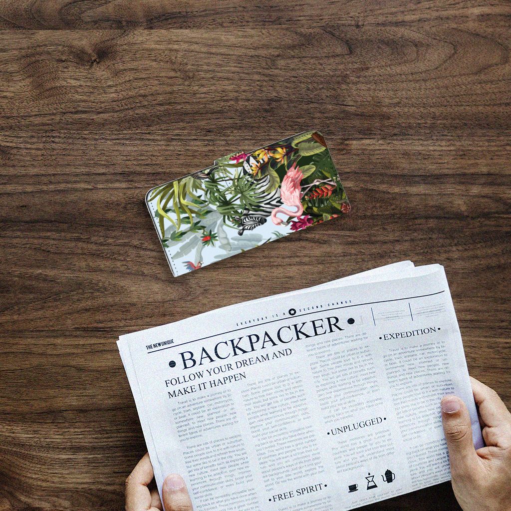 Telefoonhoesje met Pasjes voor Samsung Galaxy A14 4G Jungle op een houten tafel met een krant ernaast.