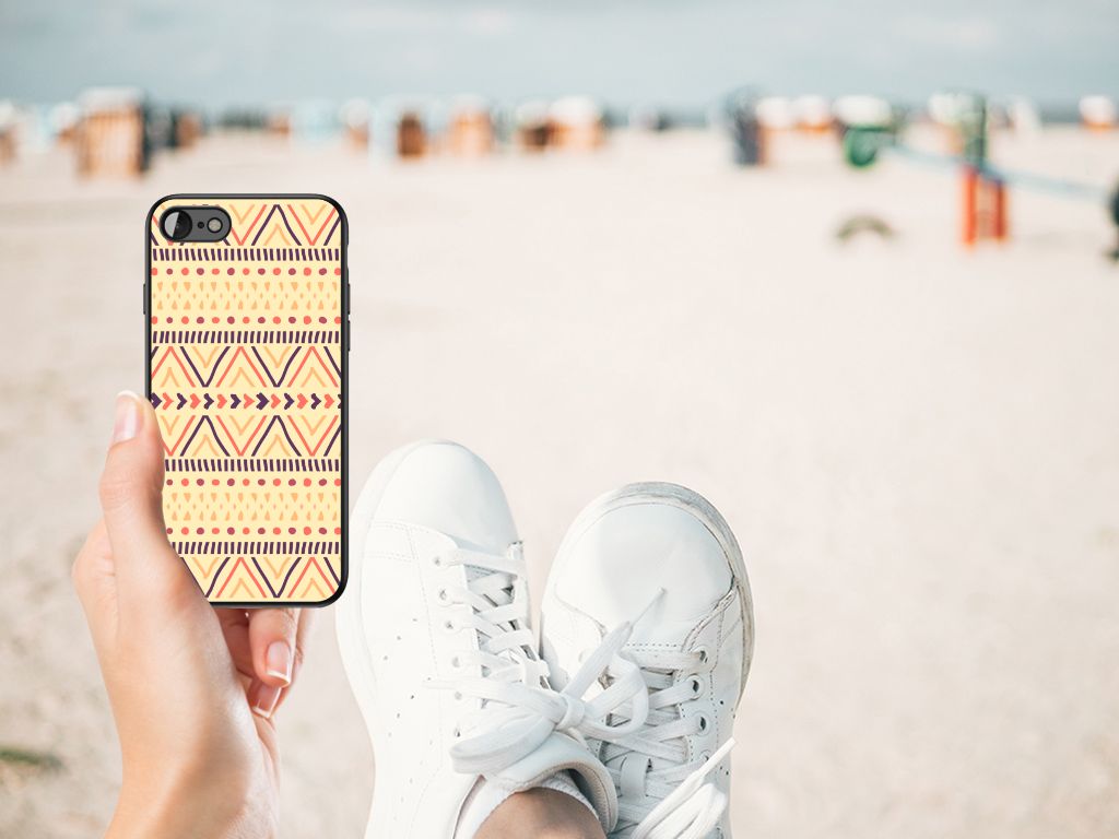 iPhone SE 2022 | SE 2020 | 7/8 Back Case Aztec Yellow in hand on beach with white sneakers.