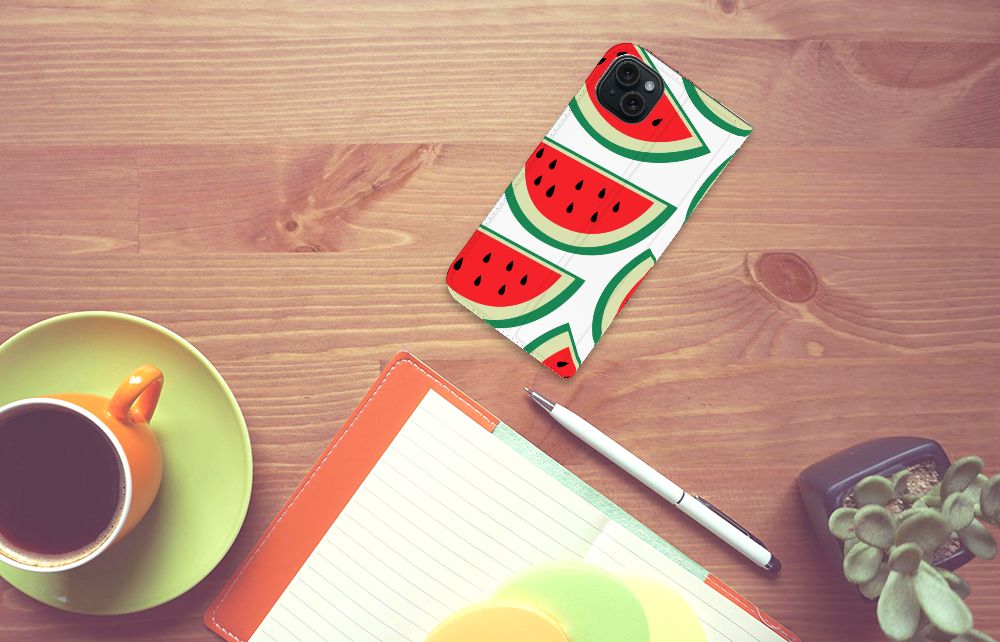iPhone 15 Plus Flip Style Cover Watermelons op een houten tafel met een kop koffie en notitieboekje.