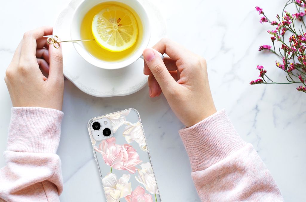 iPhone 15 Plus TPU Case Lovely Flowers displayed next to a cup of lemon tea and a hand holding a spoon.