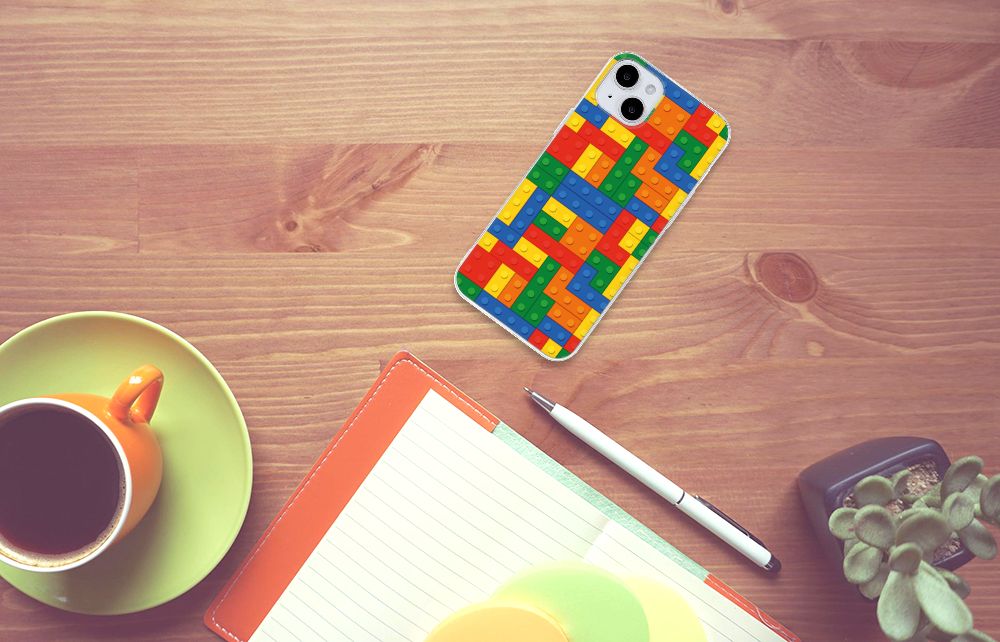 iPhone 15 Plus TPU bumper Blokken met kleurrijk Lego ontwerp op tafel met een kopje koffie ☕.